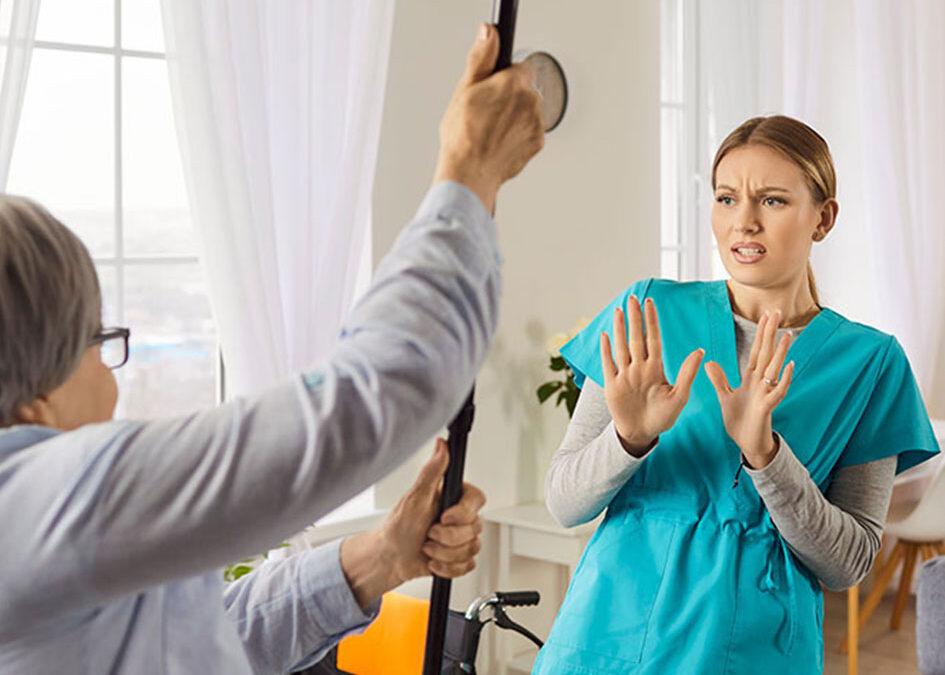 What causes aggression in dementia patients and how should families respond?